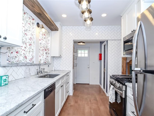 333 Lafayette Ave, Staten Island, NY 10301 - kitchen with stainless steel appliances, a sink, decorative backsplash, white cabinets, and light stone countertops