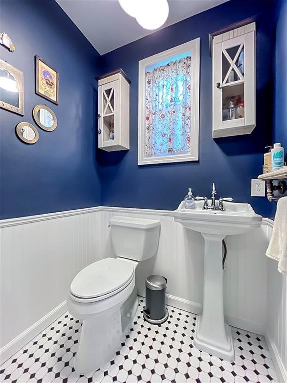 333 Lafayette Ave, Staten Island, NY 10301 - half bathroom with wainscoting, toilet, a sink, and tile patterned floors