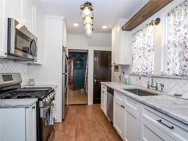 333 Lafayette Ave, Staten Island, NY 10301 - kitchen with stainless steel appliances, a sink, white cabinetry, decorative backsplash, and recessed lighting
