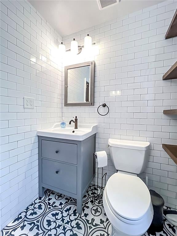 333 Lafayette Ave, Staten Island, NY 10301 - bathroom featuring tile walls, toilet, tile patterned floors, and vanity