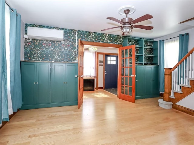 333 Lafayette Ave, Staten Island, NY 10301 - foyer entrance with a wall mounted AC, wallpapered walls, light wood-type flooring, stairs, and ceiling fan