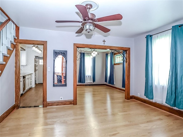 333 Lafayette Ave, Staten Island, NY 10301 - empty room featuring light wood-style floors, stairs, ceiling fan, a chandelier, and baseboards