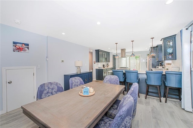dining room featuring recessed lighting and light wood finished floors