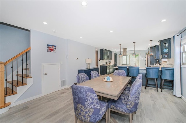 dining space featuring recessed lighting and light wood-type flooring