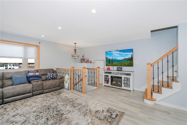 living room featuring recessed lighting, baseboards, and wood finished floors