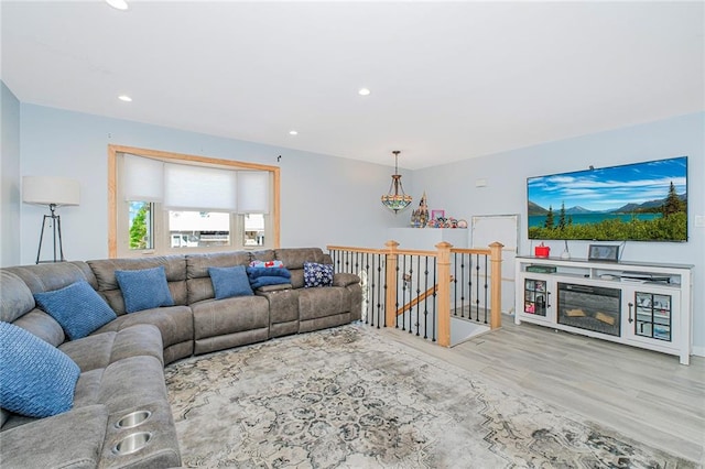living area with recessed lighting and wood finished floors
