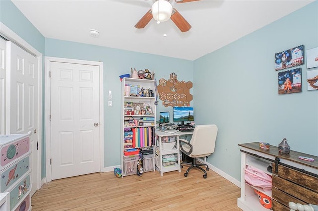 office area featuring baseboards, ceiling fan, and wood finished floors