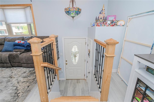 entryway with baseboards and wood finished floors
