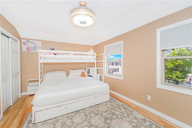 bedroom featuring baseboards and wood finished floors