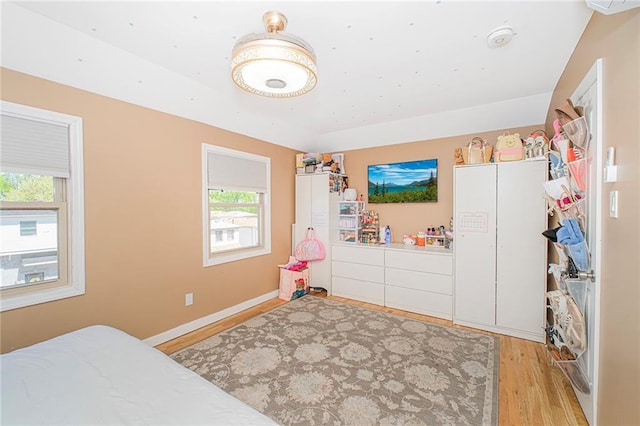 bedroom with baseboards and light wood-style flooring
