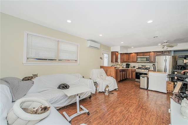 living area featuring ceiling fan, recessed lighting, a wall mounted air conditioner, and wood finished floors