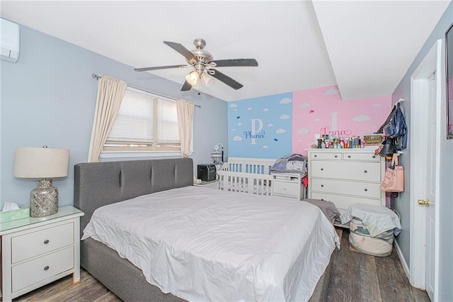 bedroom with a ceiling fan, an AC wall unit, wallpapered walls, and wood finished floors
