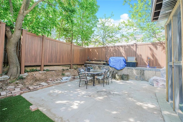 view of patio featuring outdoor dining area and a fenced backyard