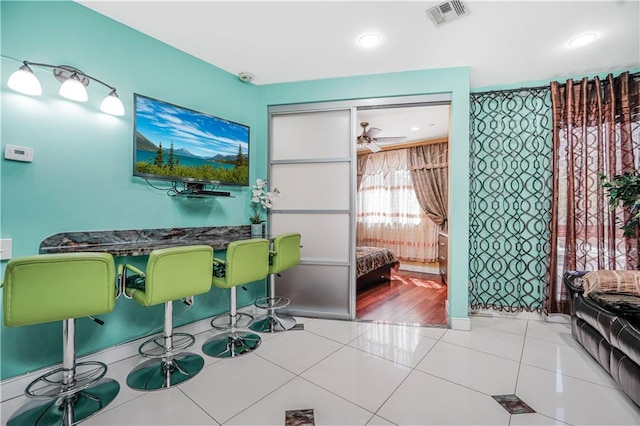 dining space featuring visible vents, a ceiling fan, baseboards, and tile patterned flooring