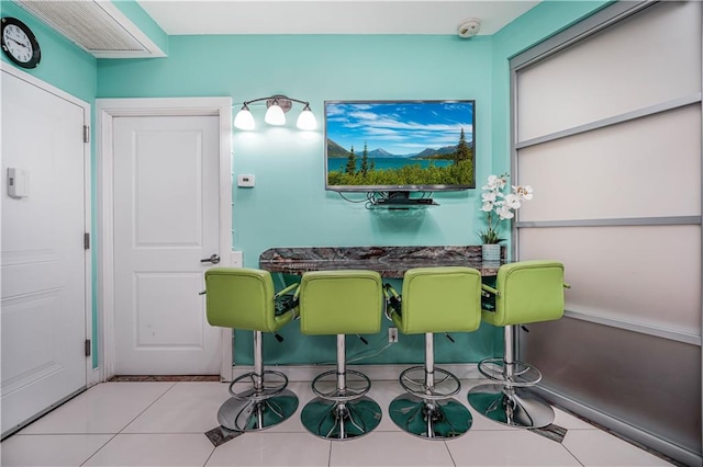 dining space with tile patterned floors