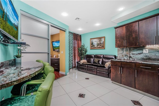 living room featuring light tile patterned floors, recessed lighting, and visible vents