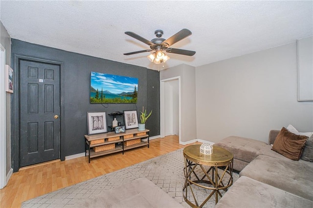 1960 Stillwell Ave, Brooklyn, NY 11223 - living area featuring light wood-style floors, ceiling fan, and a textured ceiling