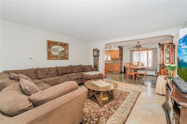 1960 Stillwell Ave, Brooklyn, NY 11223 - living room featuring arched walkways, ceiling fan, and radiator