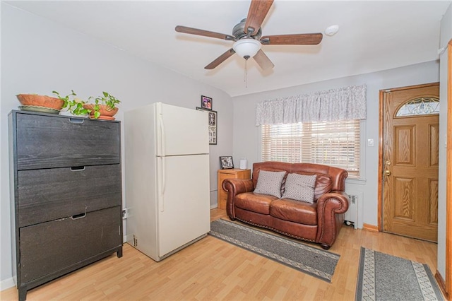 1960 Stillwell Ave, Brooklyn, NY 11223 - living area with radiator heating unit, light wood-style flooring, and ceiling fan