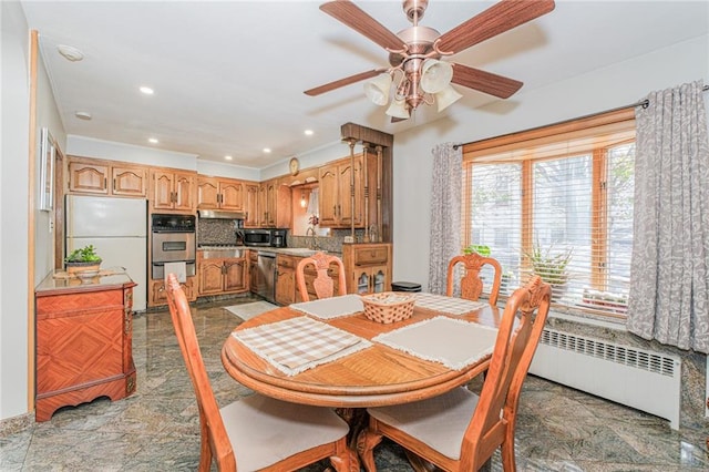 1960 Stillwell Ave, Brooklyn, NY 11223 - dining room featuring ceiling fan, radiator, recessed lighting, and stone finish flooring