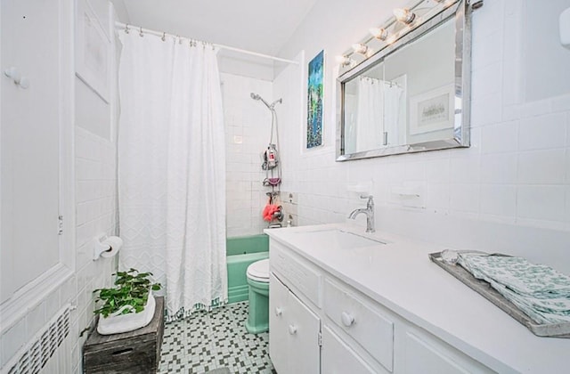 1960 Stillwell Ave, Brooklyn, NY 11223 - bathroom with vanity, tile walls, shower / bathtub combination with curtain, radiator heating unit, and tile patterned floors