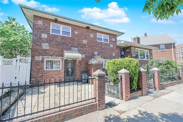 1960 Stillwell Ave, Brooklyn, NY 11223 - view of front of property with a gate, brick siding, and a fenced front yard