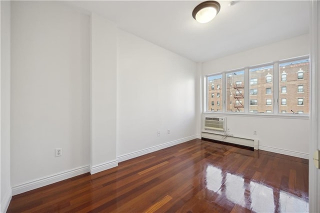 unfurnished room featuring baseboards, a baseboard radiator, wood finished floors, and an AC wall unit