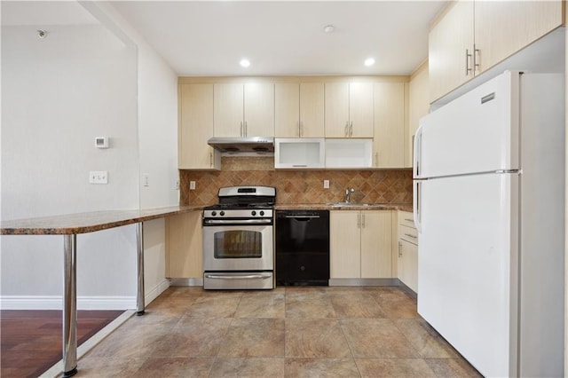 kitchen featuring dishwasher, stainless steel range with gas stovetop, freestanding refrigerator, decorative backsplash, and under cabinet range hood