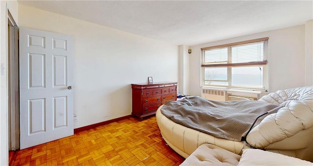bedroom with radiator heating unit and baseboards
