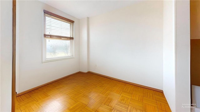 spare room with baseboards