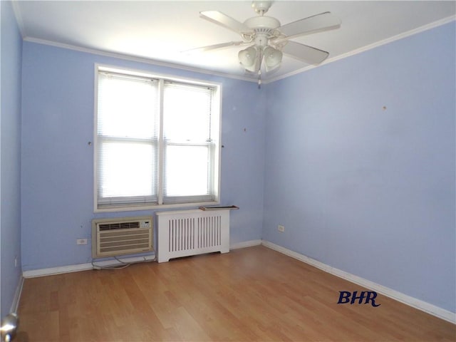 empty room featuring radiator heating unit, baseboards, crown molding, and light wood-style floors