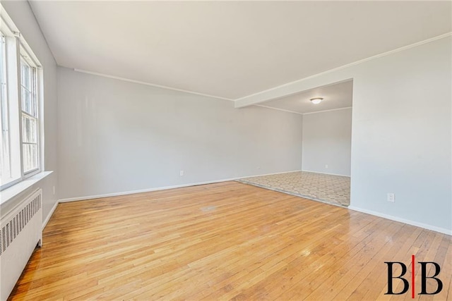1265 E 92nd St, Brooklyn, NY 11236 - unfurnished room with radiator heating unit, light wood finished floors, plenty of natural light, crown molding, and baseboards