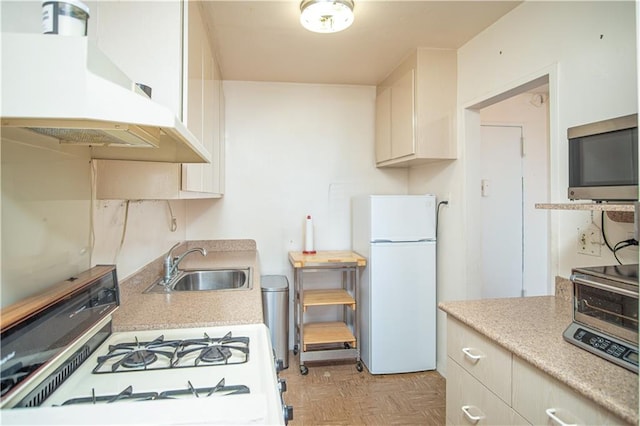 448 Neptune Ave Unit 19A, Brooklyn, NY 11224 - kitchen featuring a sink, under cabinet range hood, white appliances, and light countertops