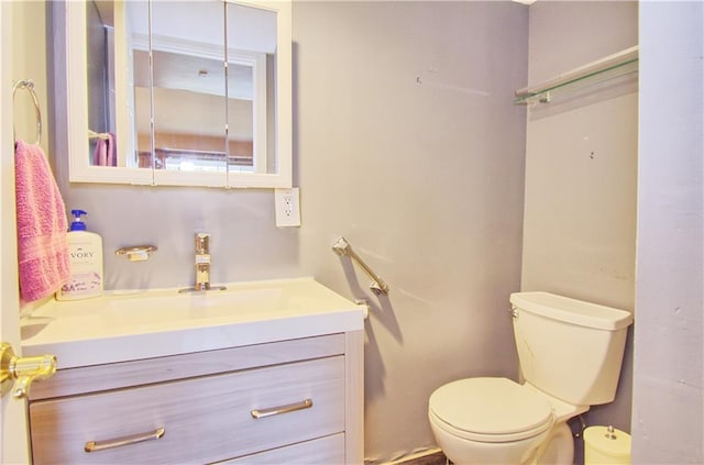 bathroom with toilet and vanity