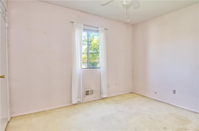 spare room with visible vents, a ceiling fan, carpet, and baseboards
