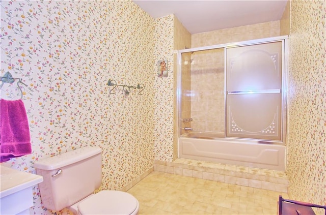 full bathroom with toilet, wallpapered walls, and shower / bath combination with glass door