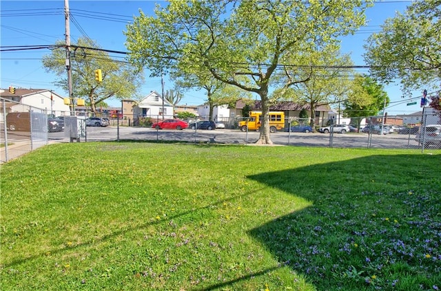 view of yard featuring fence and a residential view