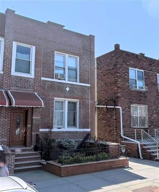 view of front of property with brick siding and cooling unit