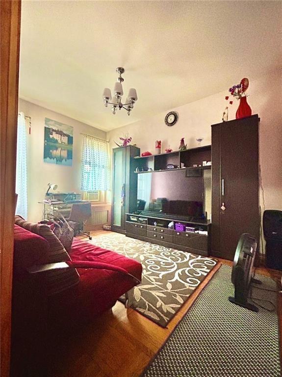 interior space with a chandelier and wood finished floors