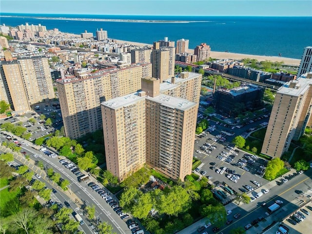 drone / aerial view featuring a view of city and a water view