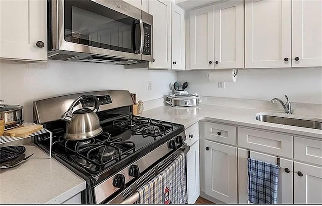 3626 Bayview Ave, Brooklyn, NY 11224 - kitchen featuring stainless steel appliances, a sink, light countertops, and white cabinetry