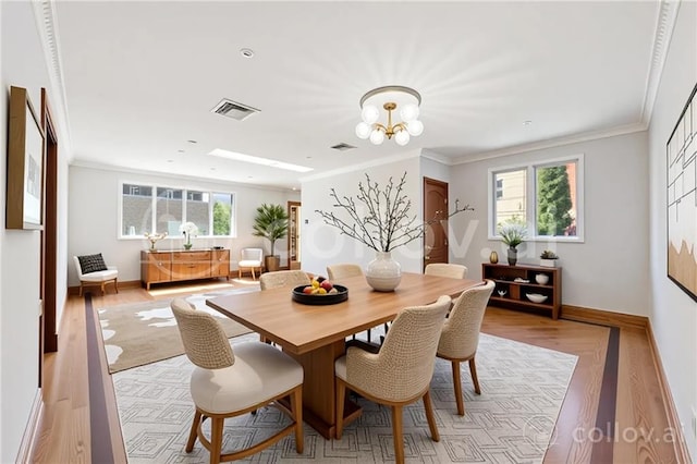 2680 E 23rd St, Brooklyn, NY 11235 - dining space with baseboards, light wood finished floors, ornamental molding, and a chandelier