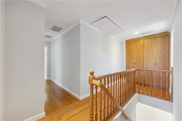 2680 E 23rd St, Brooklyn, NY 11235 - hallway featuring an upstairs landing, attic access, baseboards, ornamental molding, and light wood finished floors
