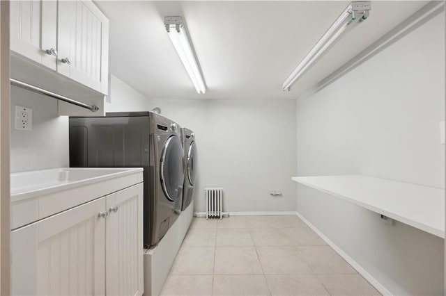 2680 E 23rd St, Brooklyn, NY 11235 - washroom with cabinet space, washing machine and clothes dryer, radiator heating unit, light tile patterned floors, and baseboards
