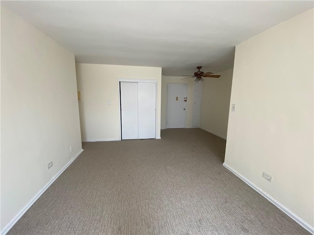 spare room featuring baseboards, carpet flooring, and ceiling fan