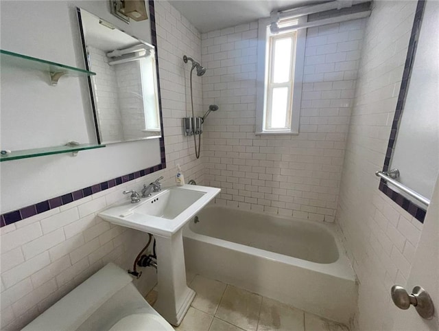 bathroom featuring tile patterned flooring,  shower combination, and tile walls