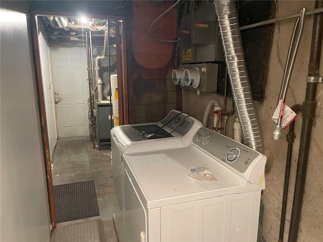 washroom featuring laundry area, washer and clothes dryer, and electric panel