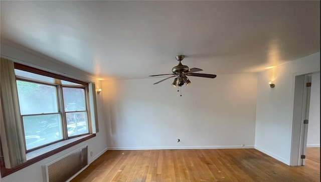 unfurnished room with baseboards, a ceiling fan, light wood-style flooring, and visible vents