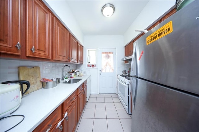 2046 Stuart St, Brooklyn, NY 11229 - kitchen featuring white appliances, a sink, under cabinet range hood, light countertops, and backsplash
