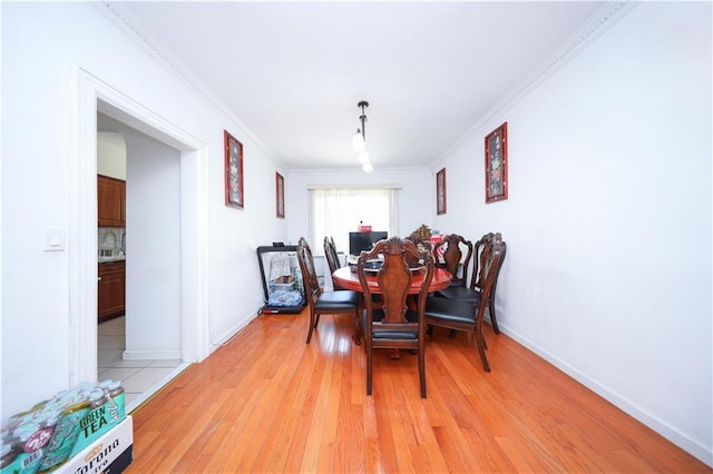 2046 Stuart St, Brooklyn, NY 11229 - dining space featuring crown molding, light wood-style flooring, and baseboards